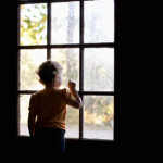 Toddler looking out the window